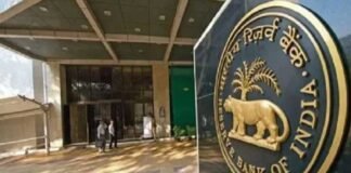Reserve Bank of India headquarters building with financial charts representing record dividend transfer to the government