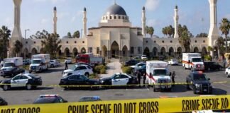 Police officers and emergency vehicles outside a mosque in San Diego after a deadly shooting incident