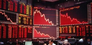Indian stock market decline Sensex Nifty red screen trading floor Mumbai