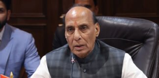 Defense Minister Rajnath Singh addressing an event while discussing India's 7.7 percent GDP growth and economic progress.