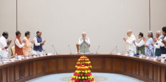 Prime Minister Narendra Modi receives a standing ovation from NDA leaders during a meeting at Bharat Mandapam in New Delhi.