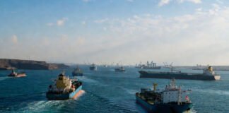 Cargo vessels navigating through the Strait of Hormuz as Iran discusses new operational rules for the strategic waterway.
