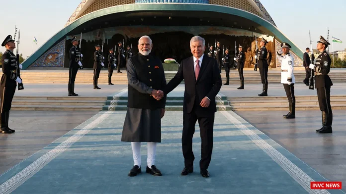 pm-modi-mirziyoyev-tashkent-welcome PM Narendra Modi and Uzbekistan President Shavkat Mirziyoyev shake hands during the Tashkent welcome