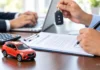 Indian car owner reviewing documents for car insurance renewal after a claim.
